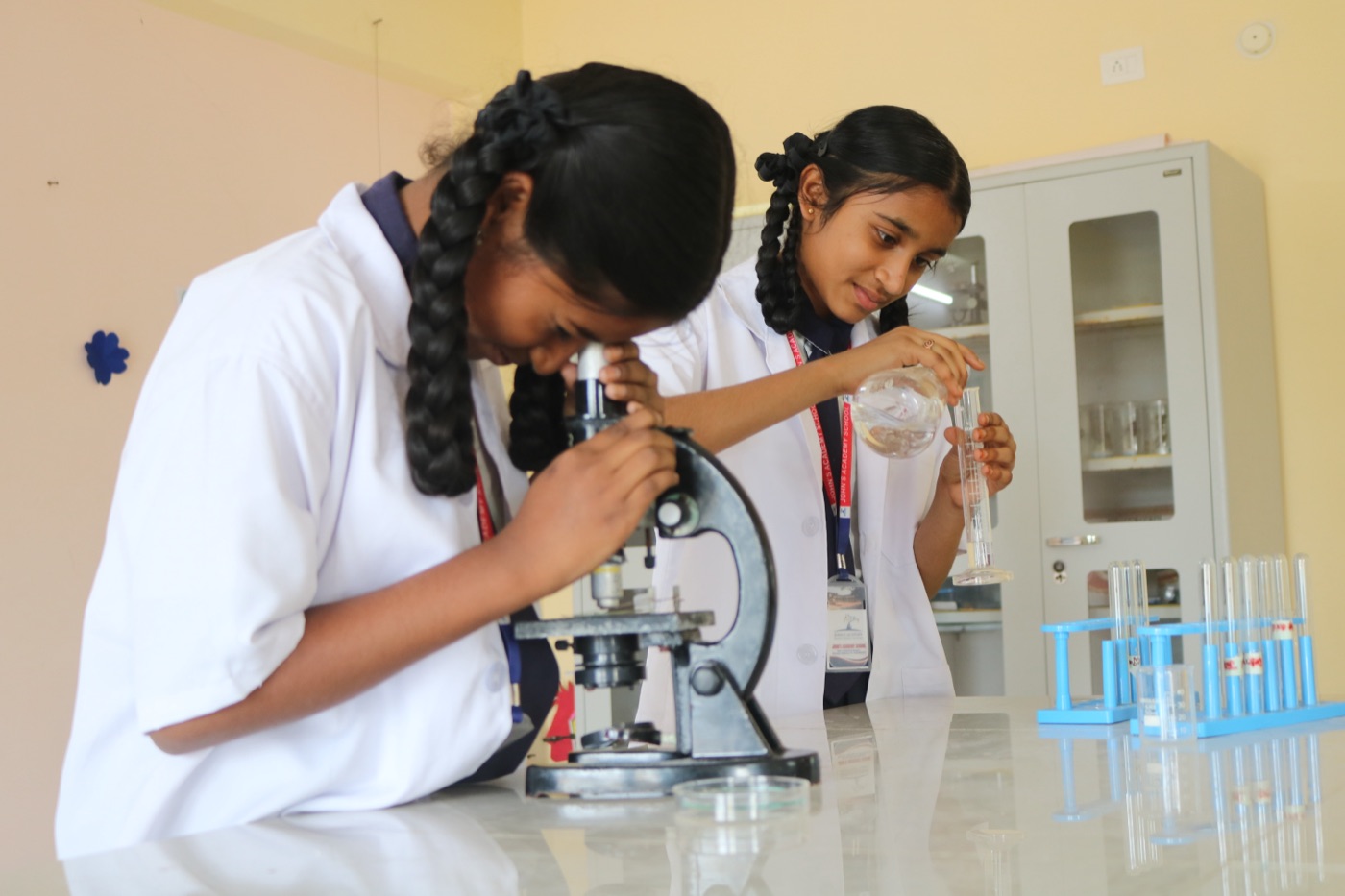 John's Academy students using a microscope in the science laboratory
