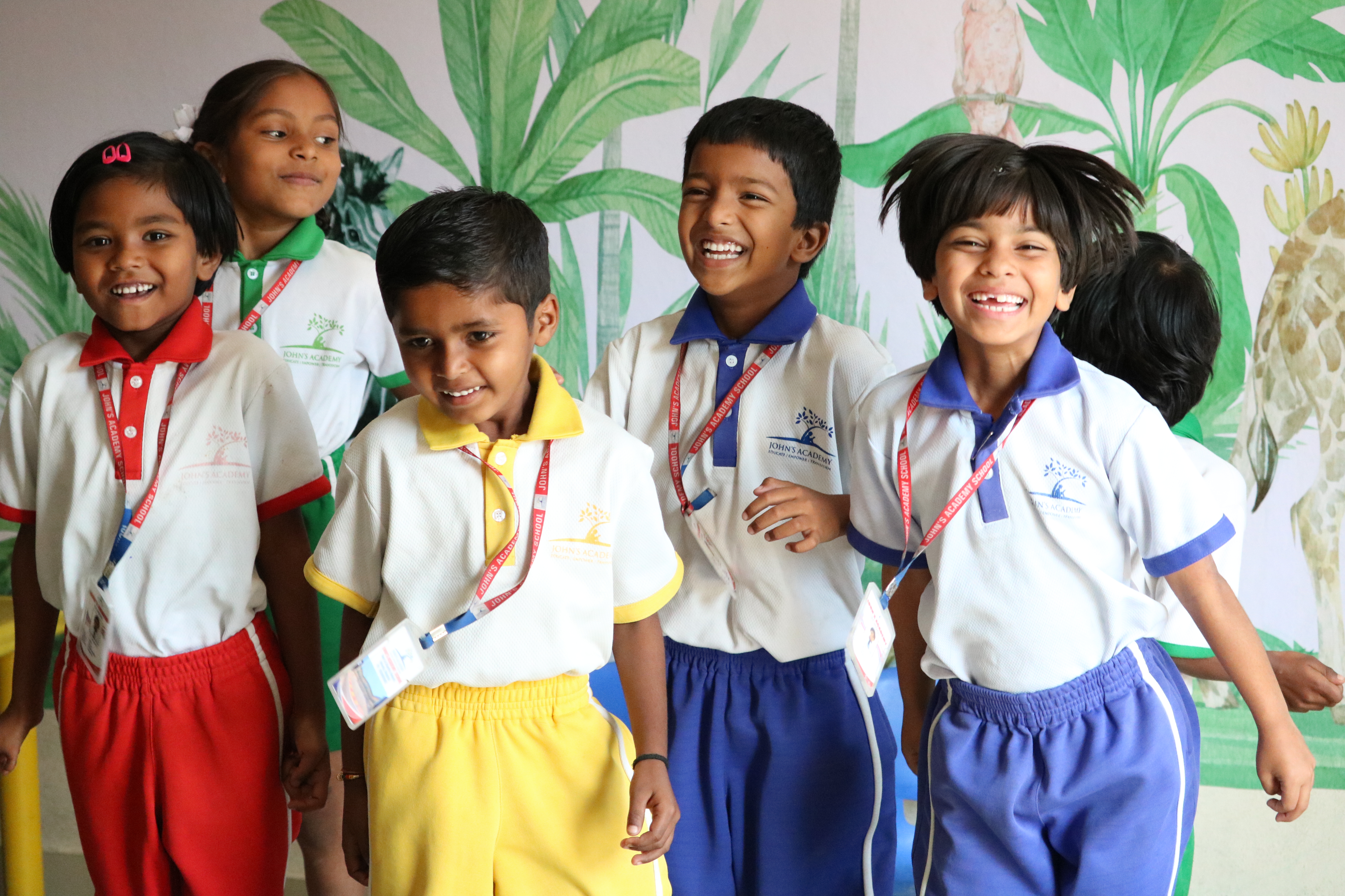 Happy young John's Academy students smiling together