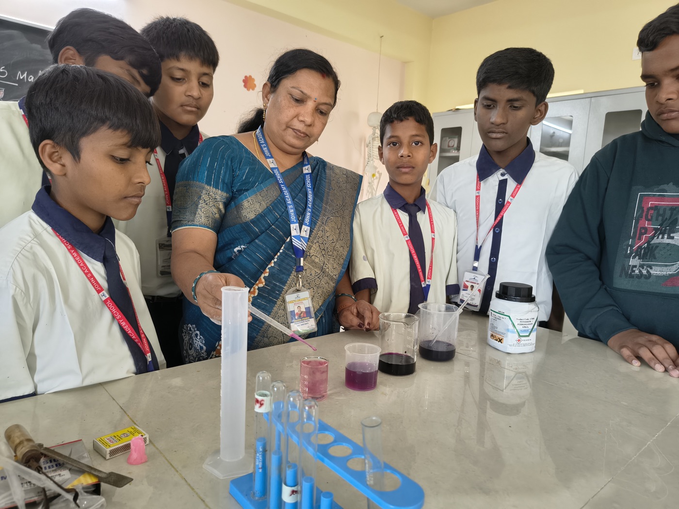 Teacher demonstrating a science experiment to students in the lab